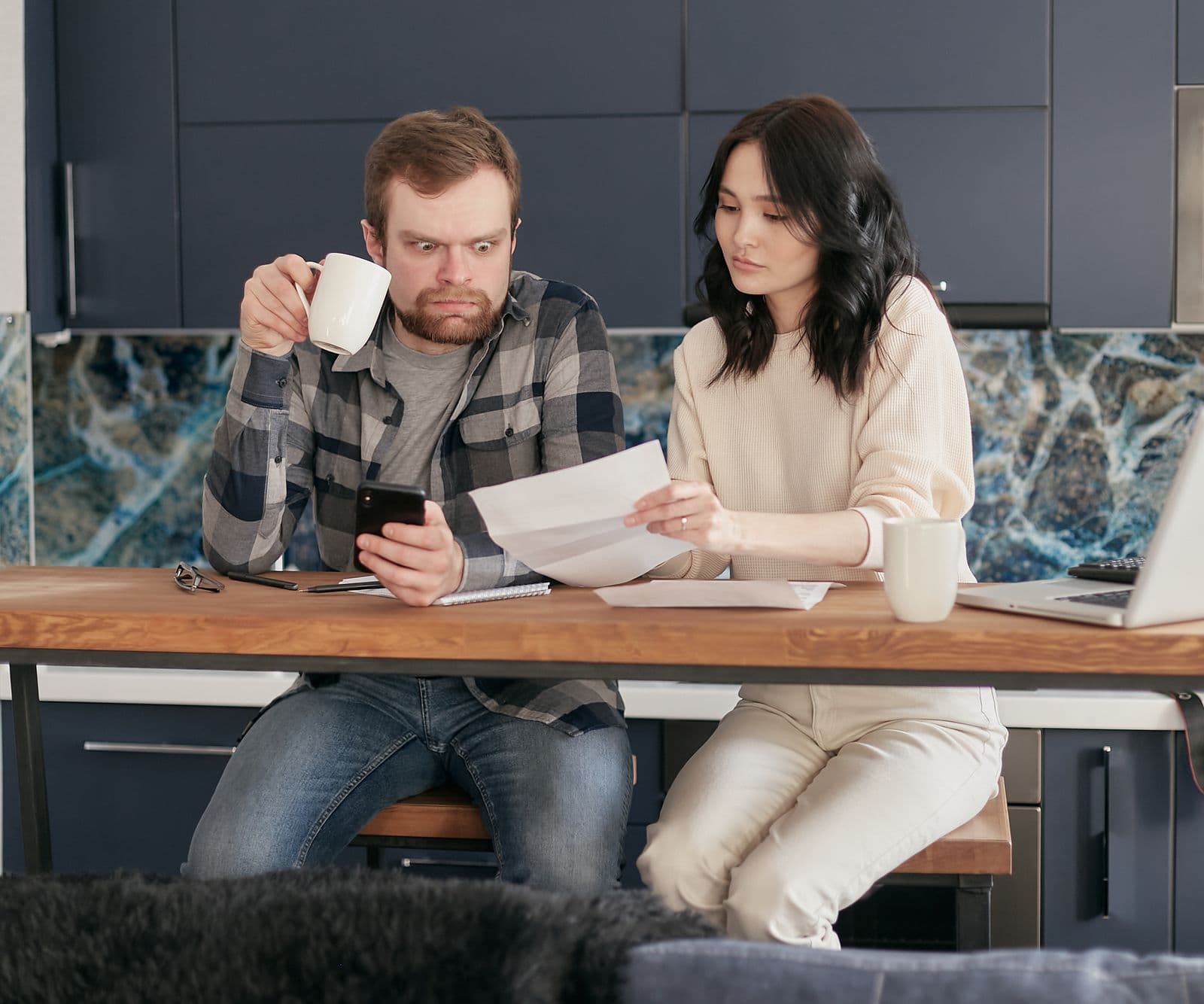 Person looking frustrated while trying to complete an online booking form on a smartphone