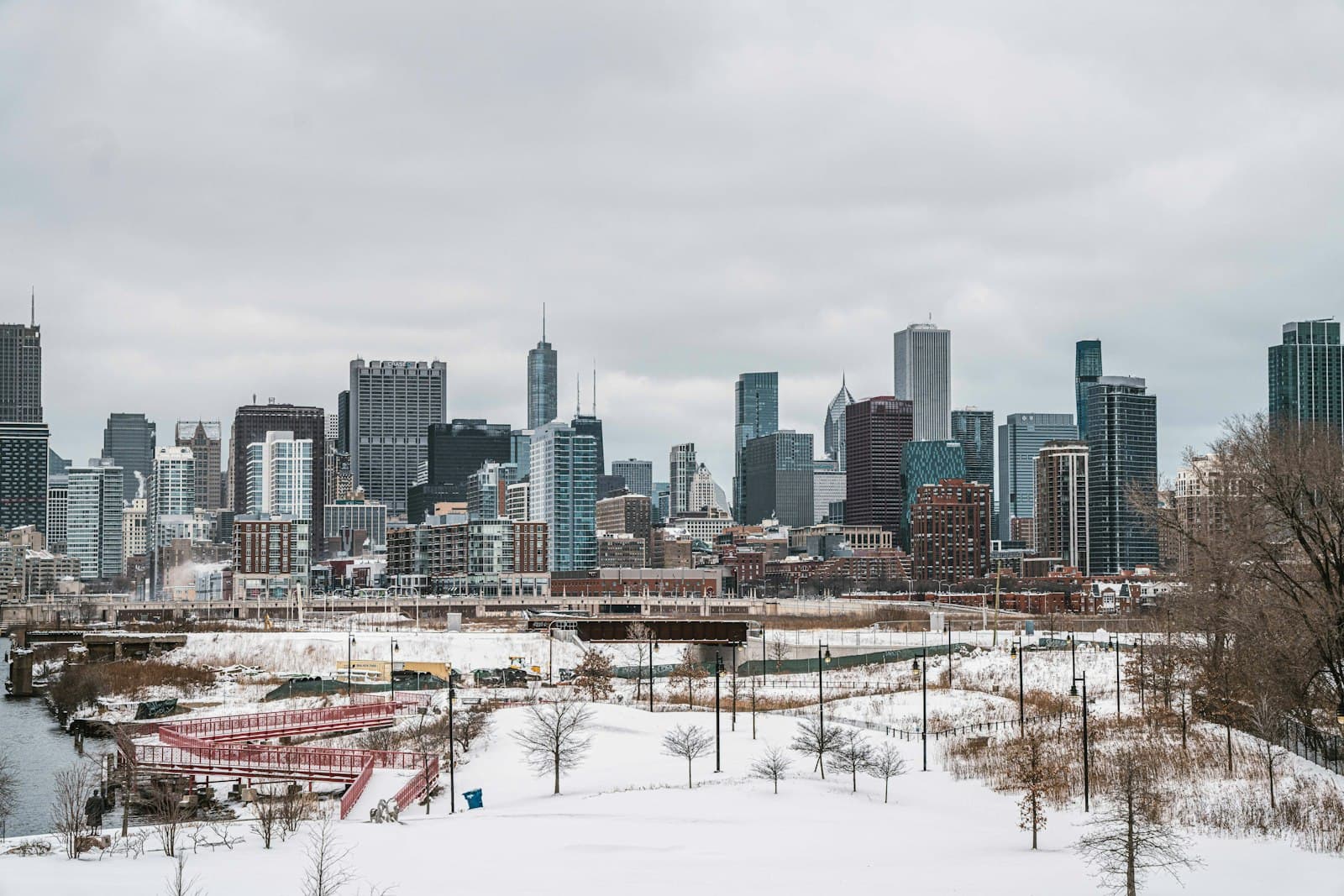 Chicago city skyline with the river in the foreground and downtown skyscrapers under a grey winter sky