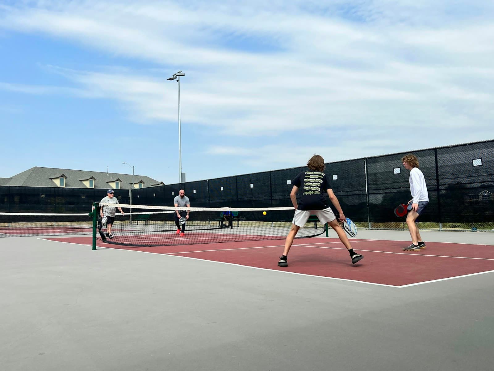 Group of pickleball players on an indoor court in doubles formation
