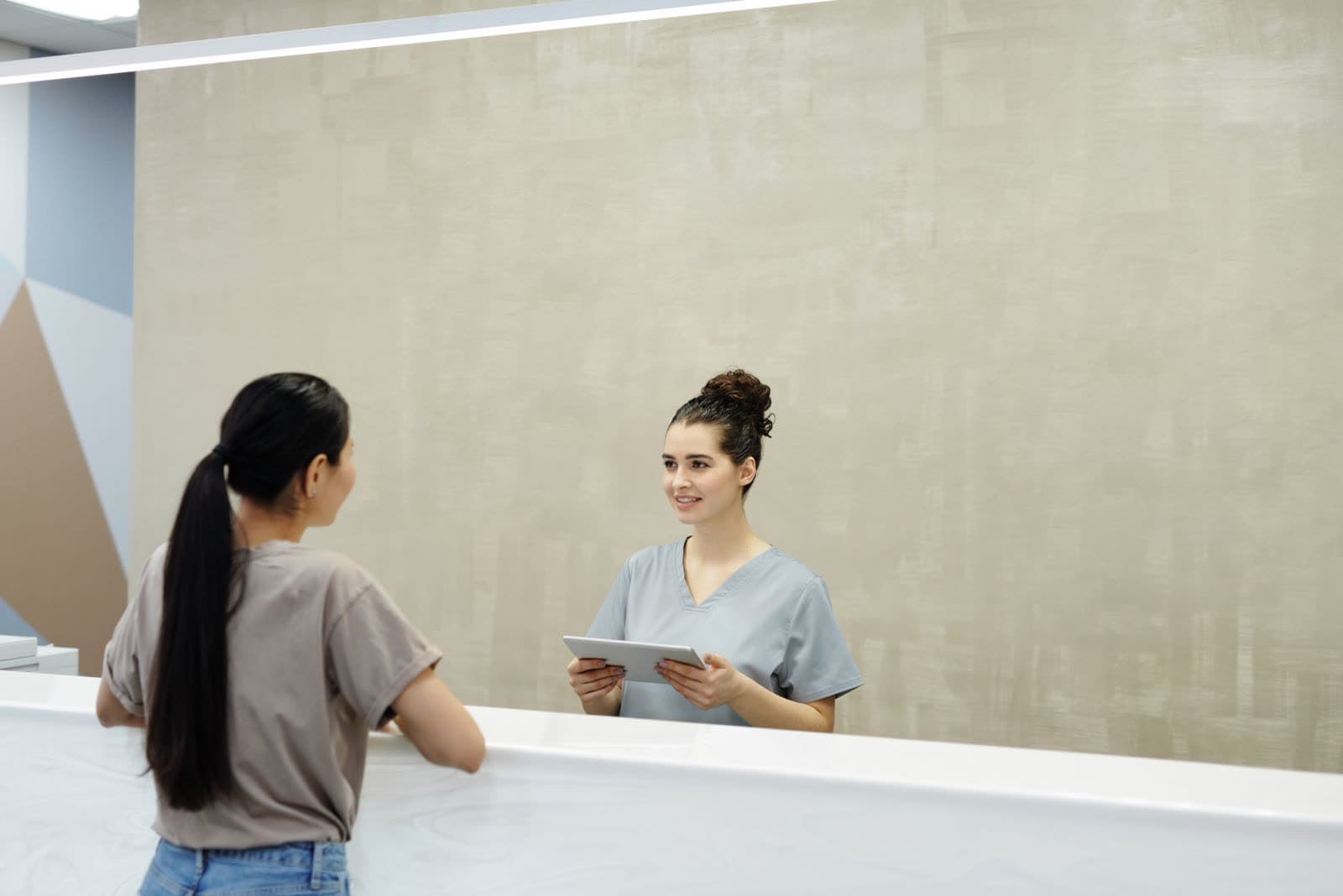 Staff member speaking with a customer at a front desk
