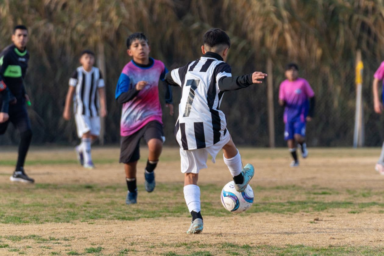 Youth players competing in a local outdoor soccer match